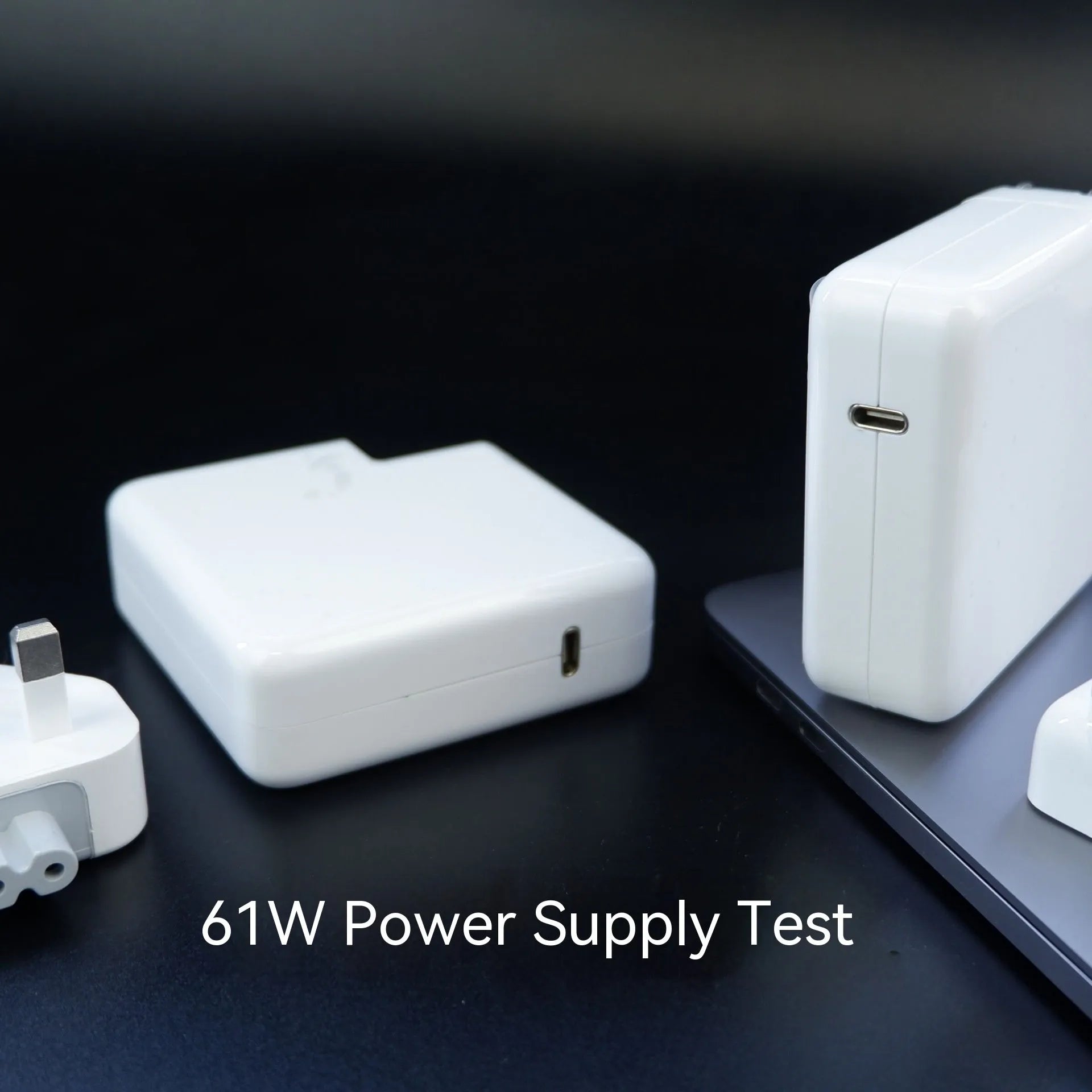 61W USB-C laptop charger with international UK EU US AU plugs measuring 7x7x3cm