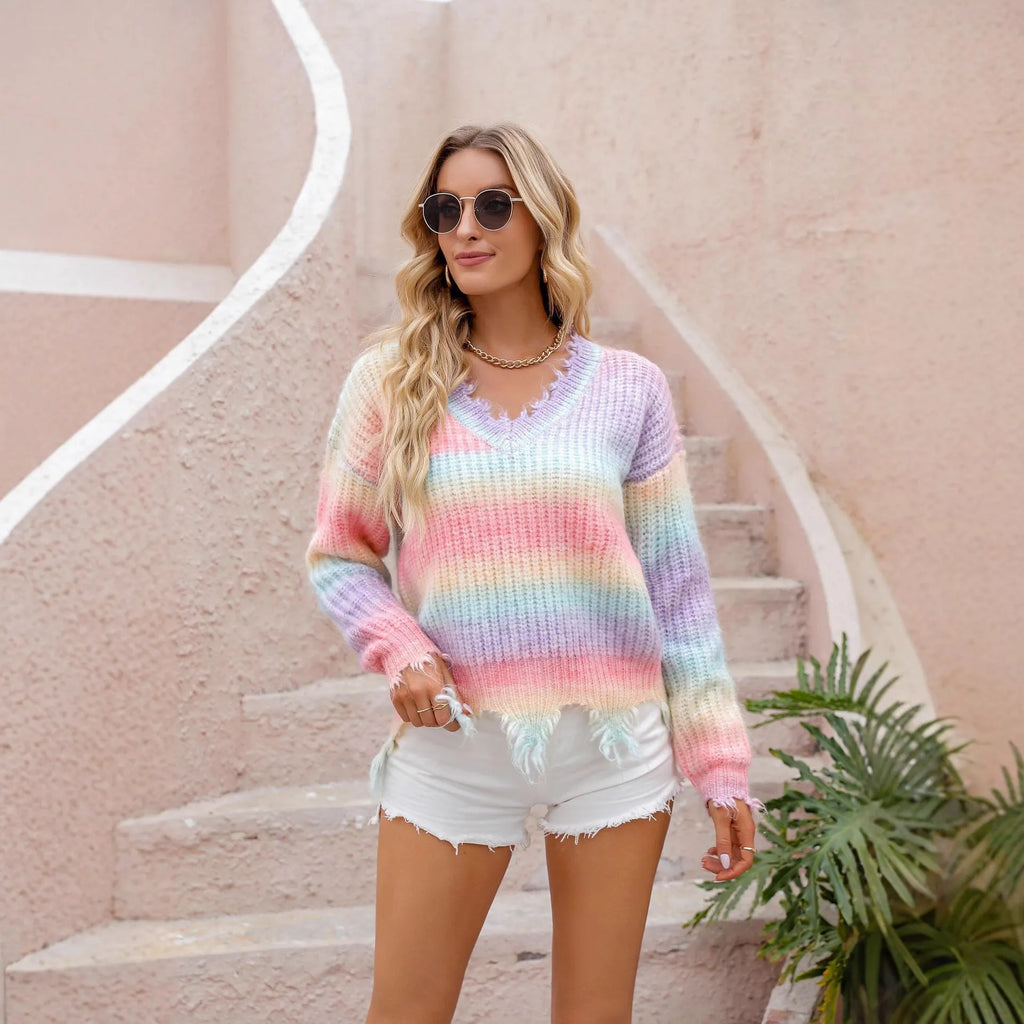 Pink rainbow gradient knitted sweater with loose cut design and tassel details