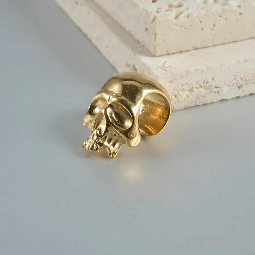 Stainless steel hollow skull and Buddha head geometric earrings in gold, black, steel, and Buddha finishes.