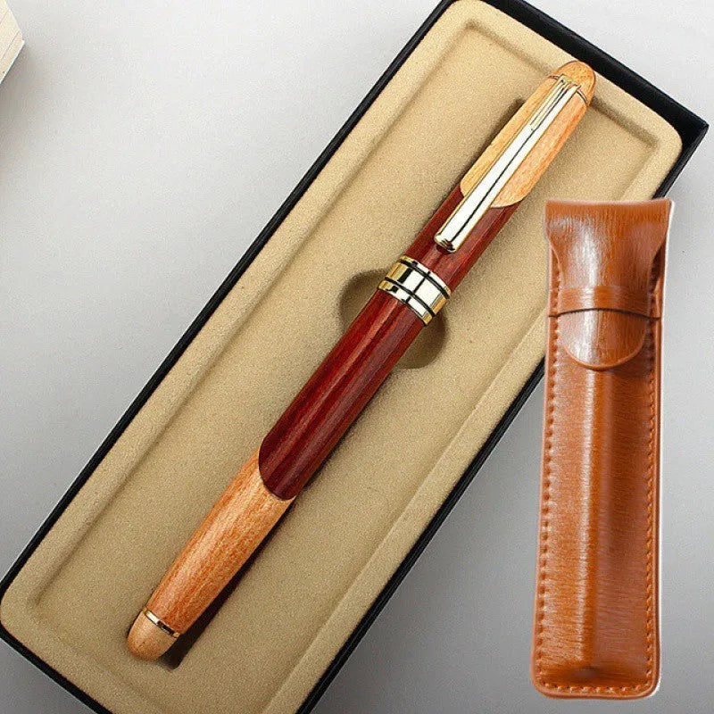Wooden fountain pen with a metal clip next to a fabric pen bag on a desk.