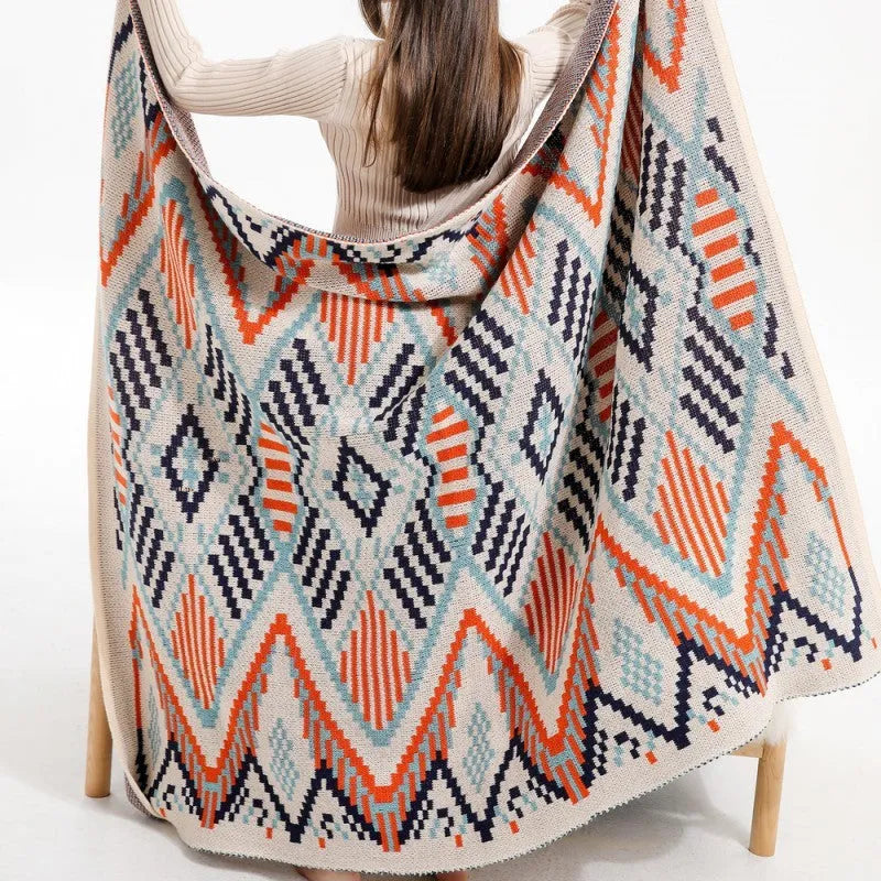 Bohemian-style acrylic knit sofa blanket with tassels in a geometric pattern