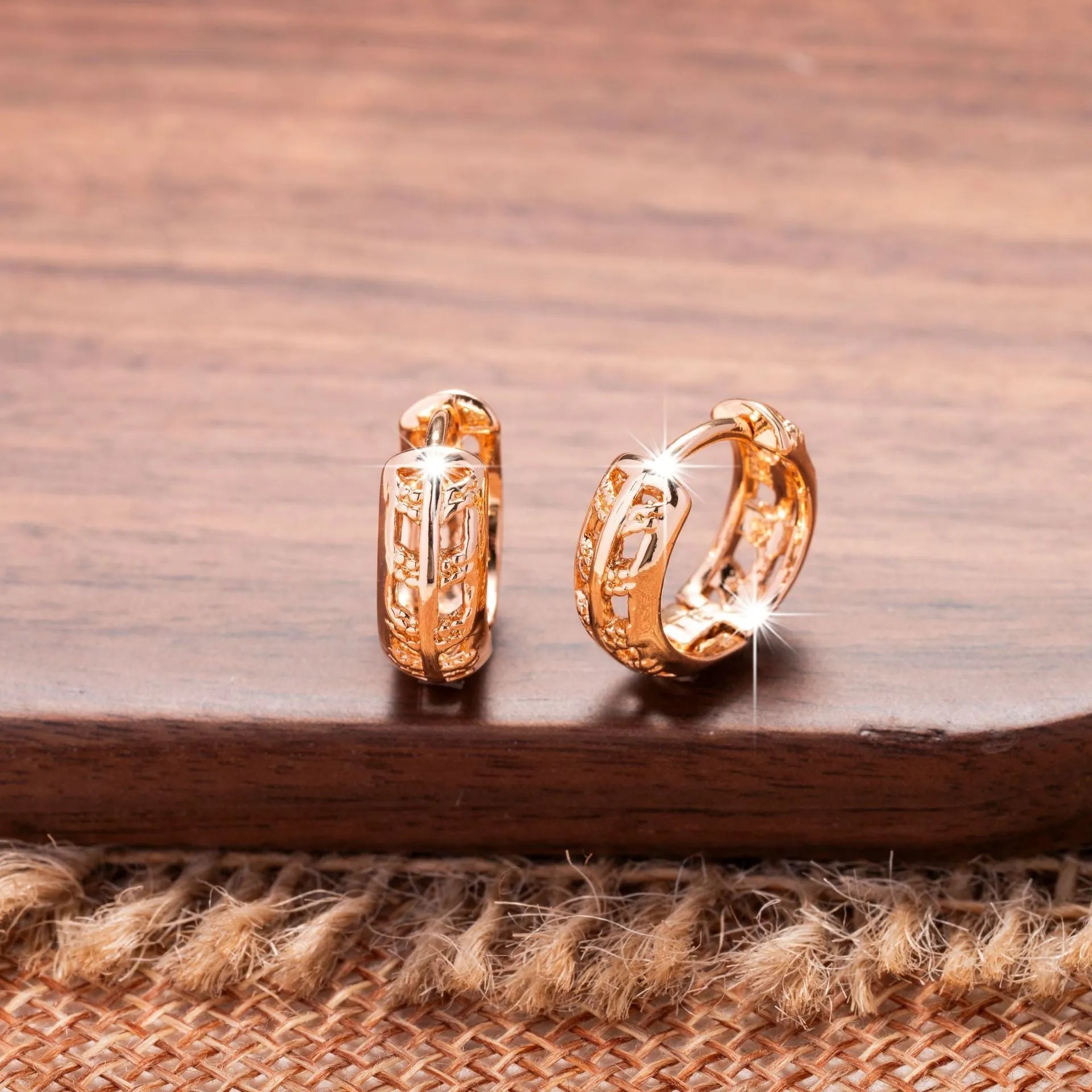 Rose gold plated hollowed-out heart and leaf shaped earrings on a white background.
