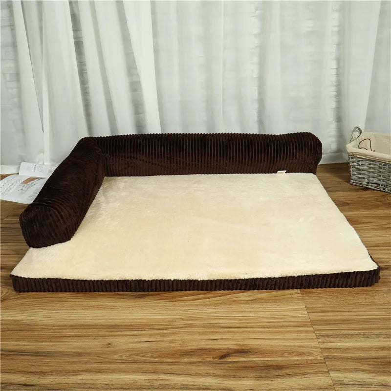 A corduroy dog sofa bed with a raised bolster side, shown in a grey colour on a wooden floor.
