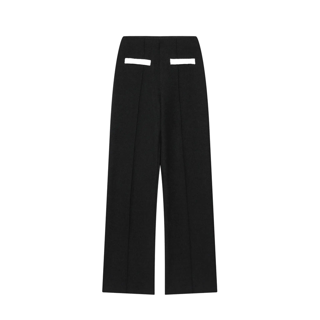 Women's casual suit set with a beaded leather top and high-waisted trousers on a model.