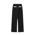 Women's casual suit set with a beaded leather top and high-waisted trousers on a model.