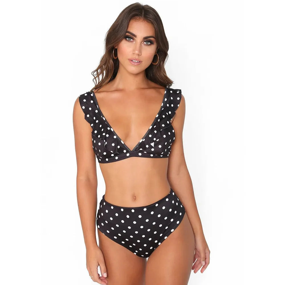 Women's black and white polka dot print bikini set with ruffled deep V-neck top and matching shorts
