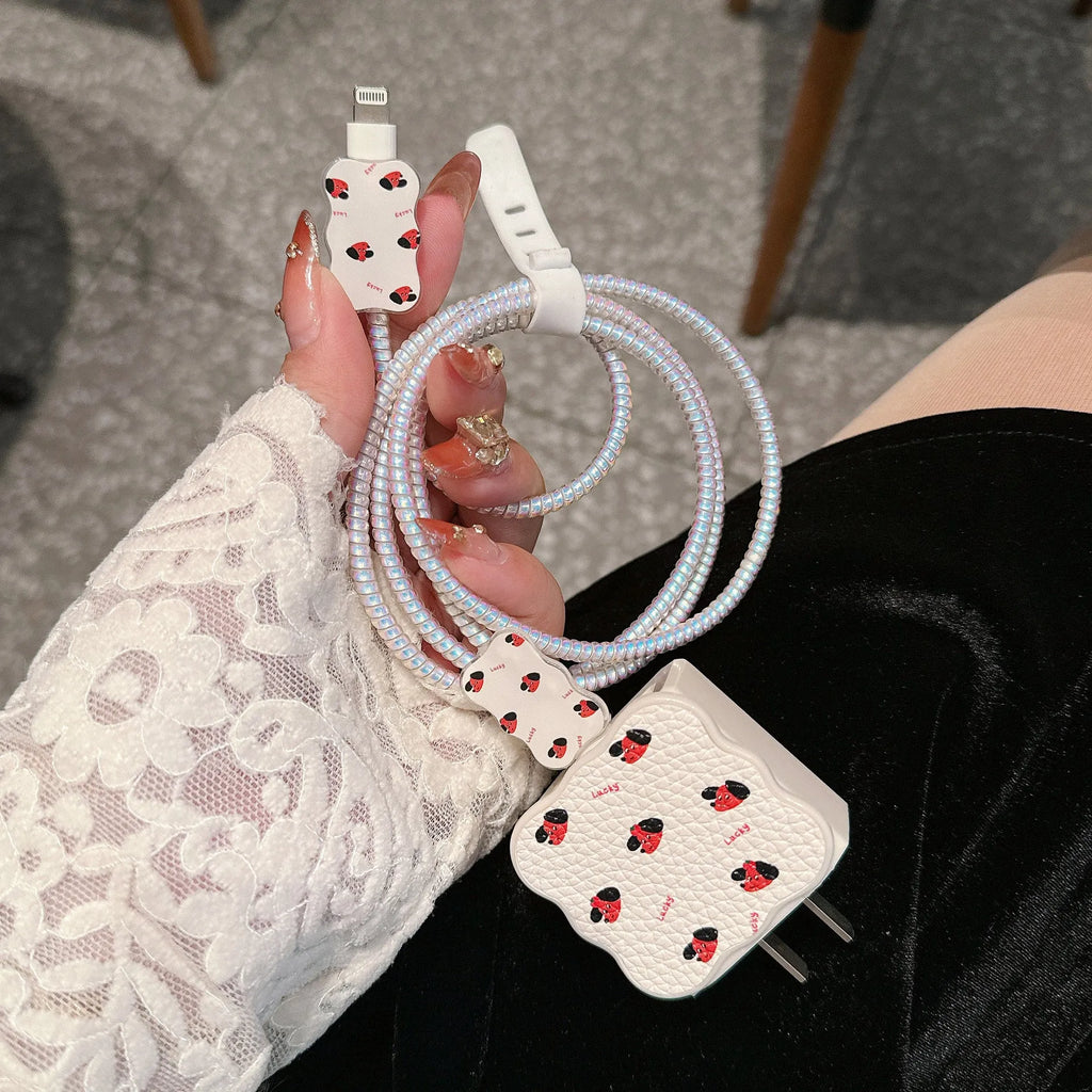 Set of four lambskin USB cable protection sleeves in checkered puppy and other cartoon dog designs.