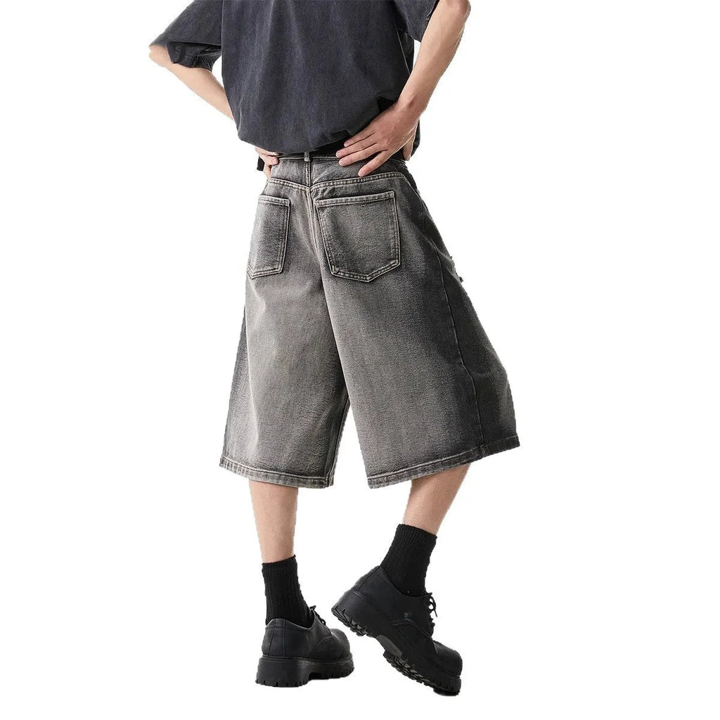 Grey women's denim shorts with water washed finish and hole distressing, loose cropped fit