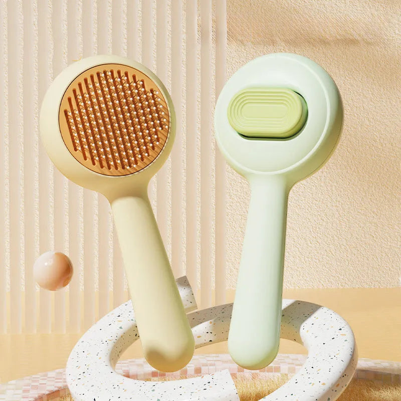 Green and yellow cat grooming brush with stainless steel pins and non-slip ergonomic handle