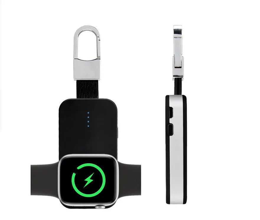 Black Apple Watch keychain power bank with wireless charging pad next to an Apple Watch.