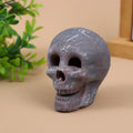 White ceramic skull barbecue model ornament on a flat surface.