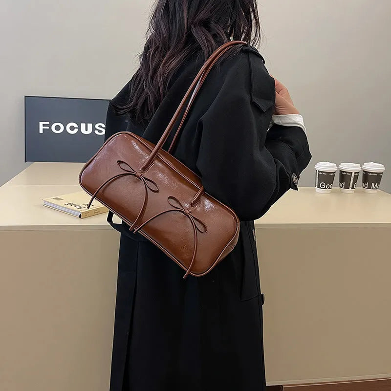 Soft PU pillow underarm bag in brown with bow, stitching and contrast colour details, large capacity women's daily matching bag
