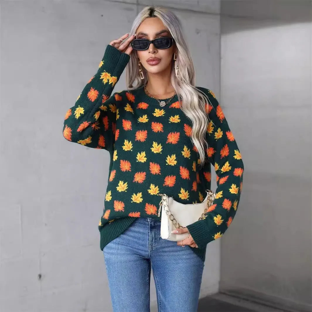 Beige loose fit Maple Leaf Christmas print pullover sweater with contrast details on a hanger.