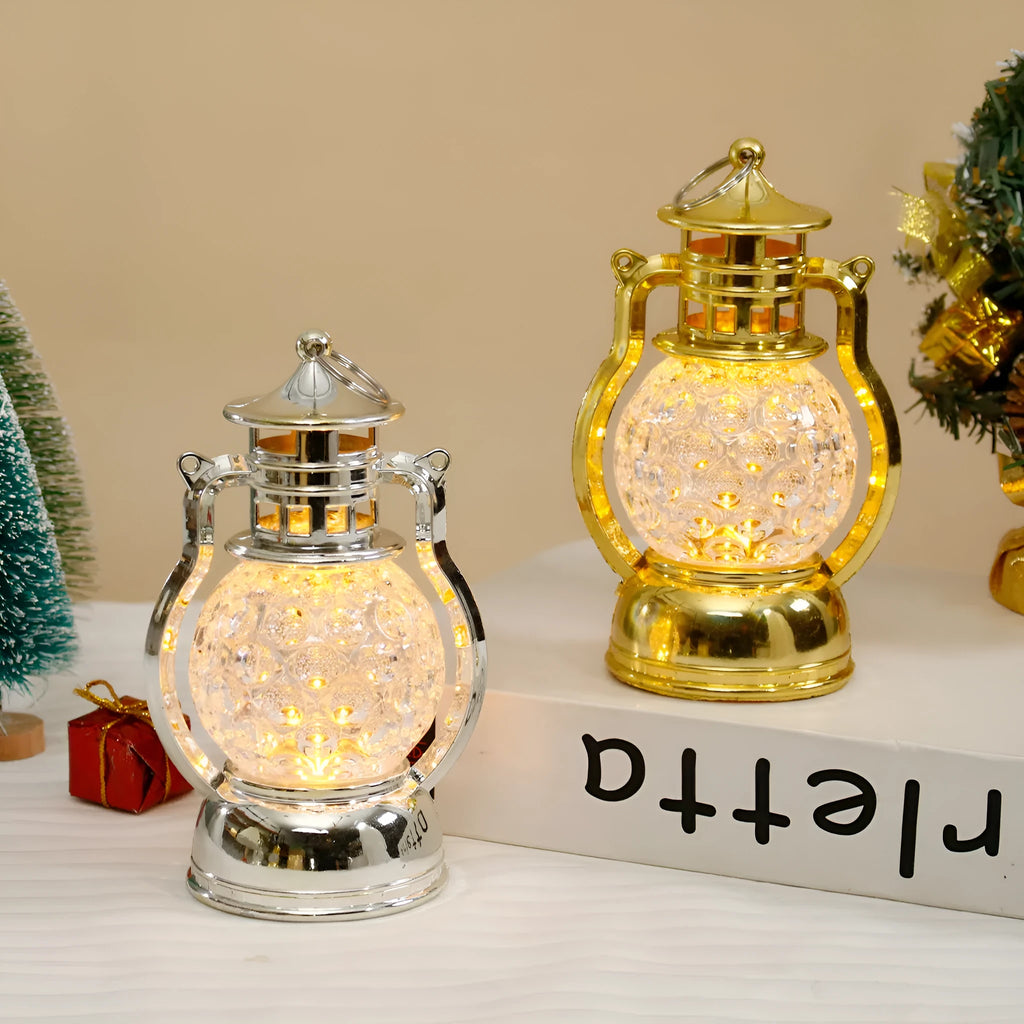 Small retro-style oil lamp LED night light in gold or silver finish on a table.