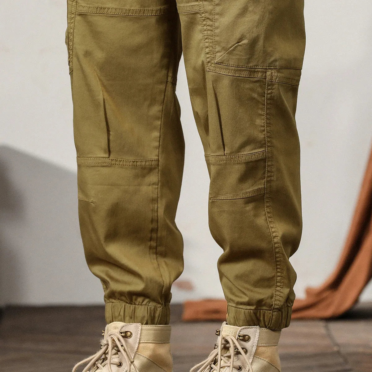 Men's cotton harem pants with tapered ankle cuffs in black colour showing loose fit and zip fly closure