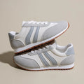 Blue and grey Cortez stripe casual sports shoes with flat heel and round toe on a wear-resistant rubber sole.