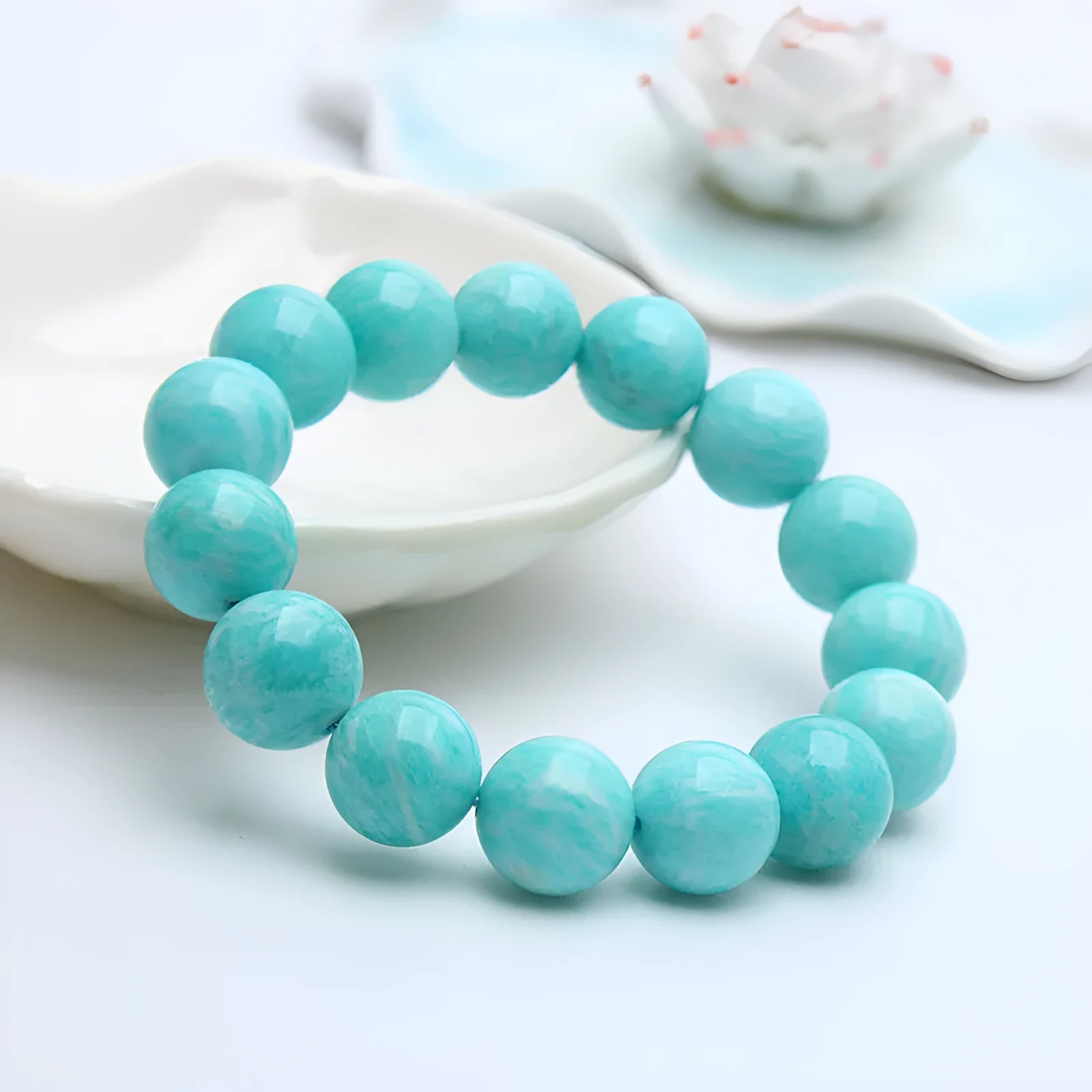 Natural blue-green Amazonite gemstone bracelet with adjustable closure on a wrist.