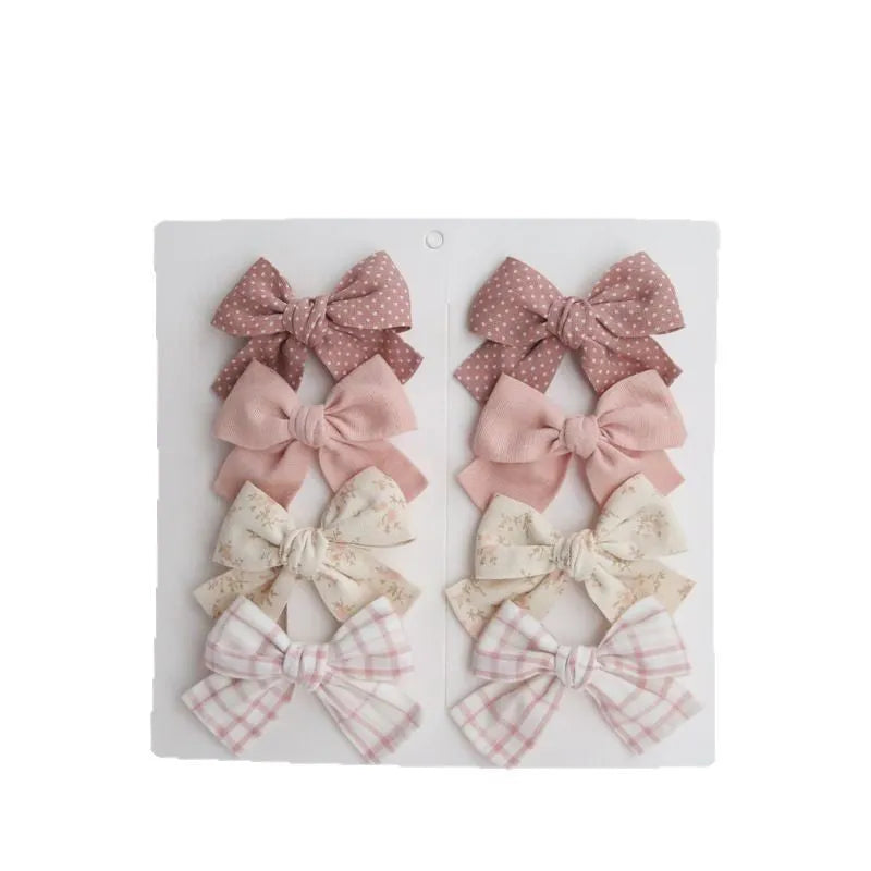Dovetail bow hairclip set for children in cloth material with eight colour options