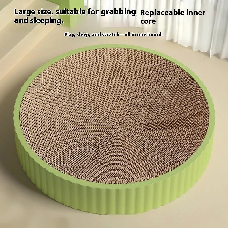 Green round cat scratching board with corrugated paper centre and two white replacement pads.