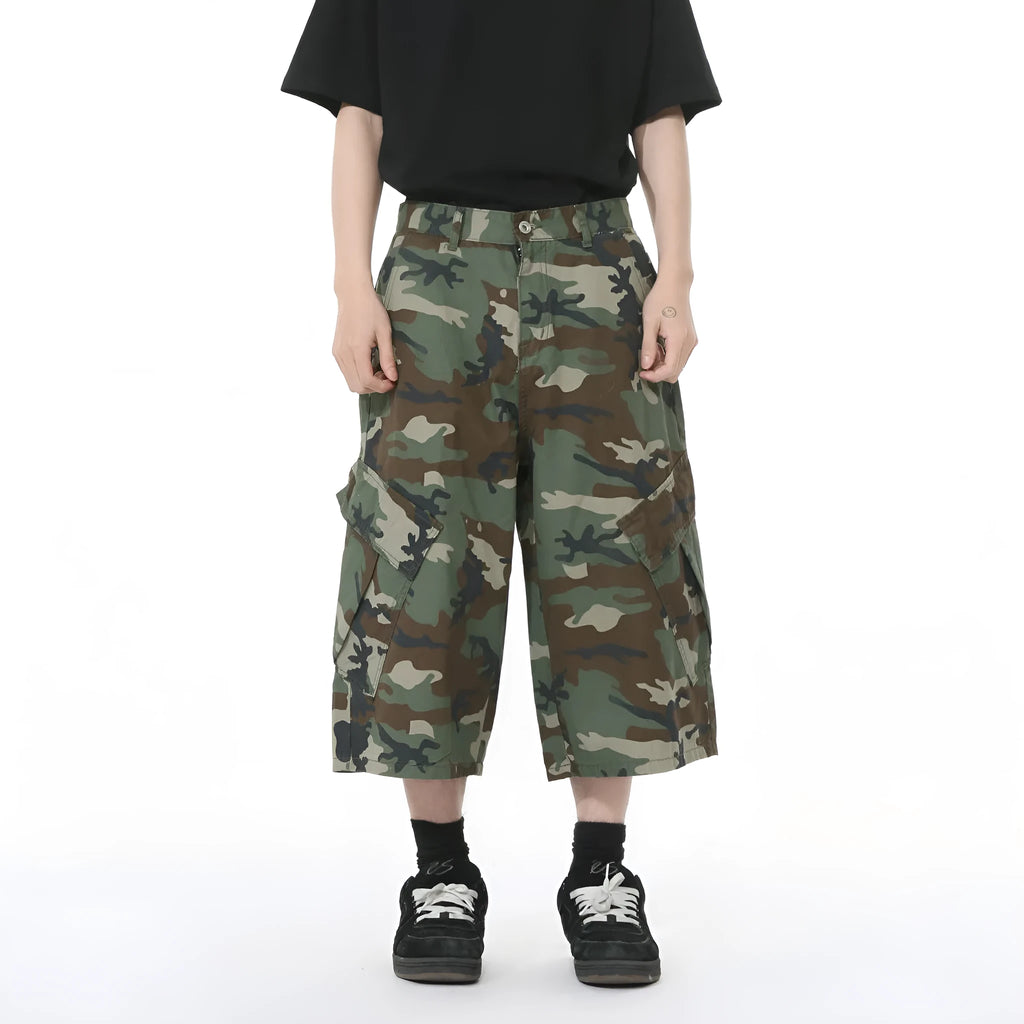 Men's cotton camouflage wide-leg cargo trousers with cropped length on a neutral background.