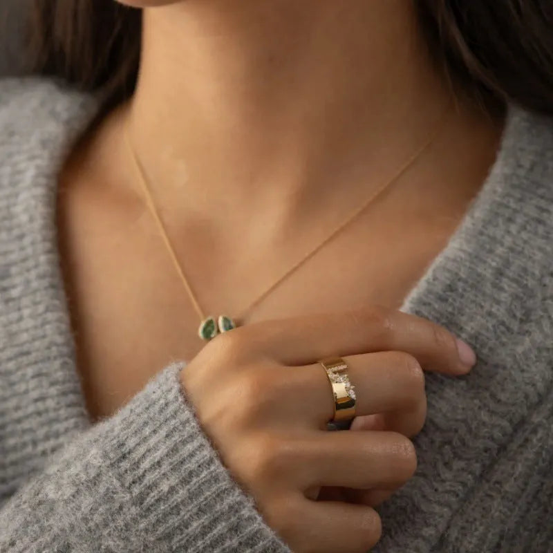 Gold electroplated women's ring with shining zircon stone on a copper band.
