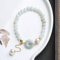 Jade green pearl bracelet with peace buckle fastening and round geometric pendant for women