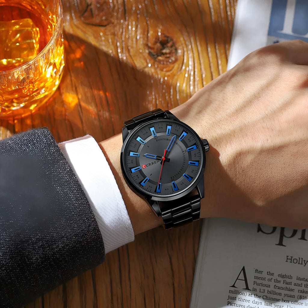 Men's silver business quartz watch with stainless steel strap and white dial with blue hour markers on a light background