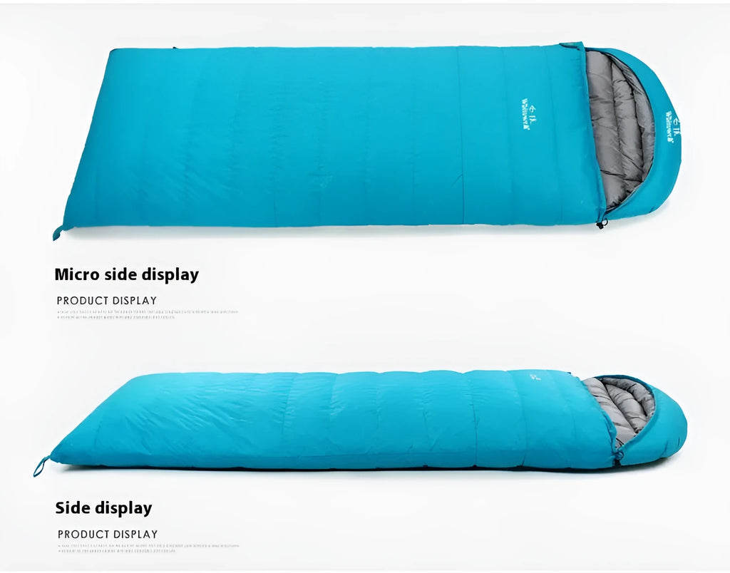 Black outdoor sleeping bag with thick goose down fill on a grassy campsite.