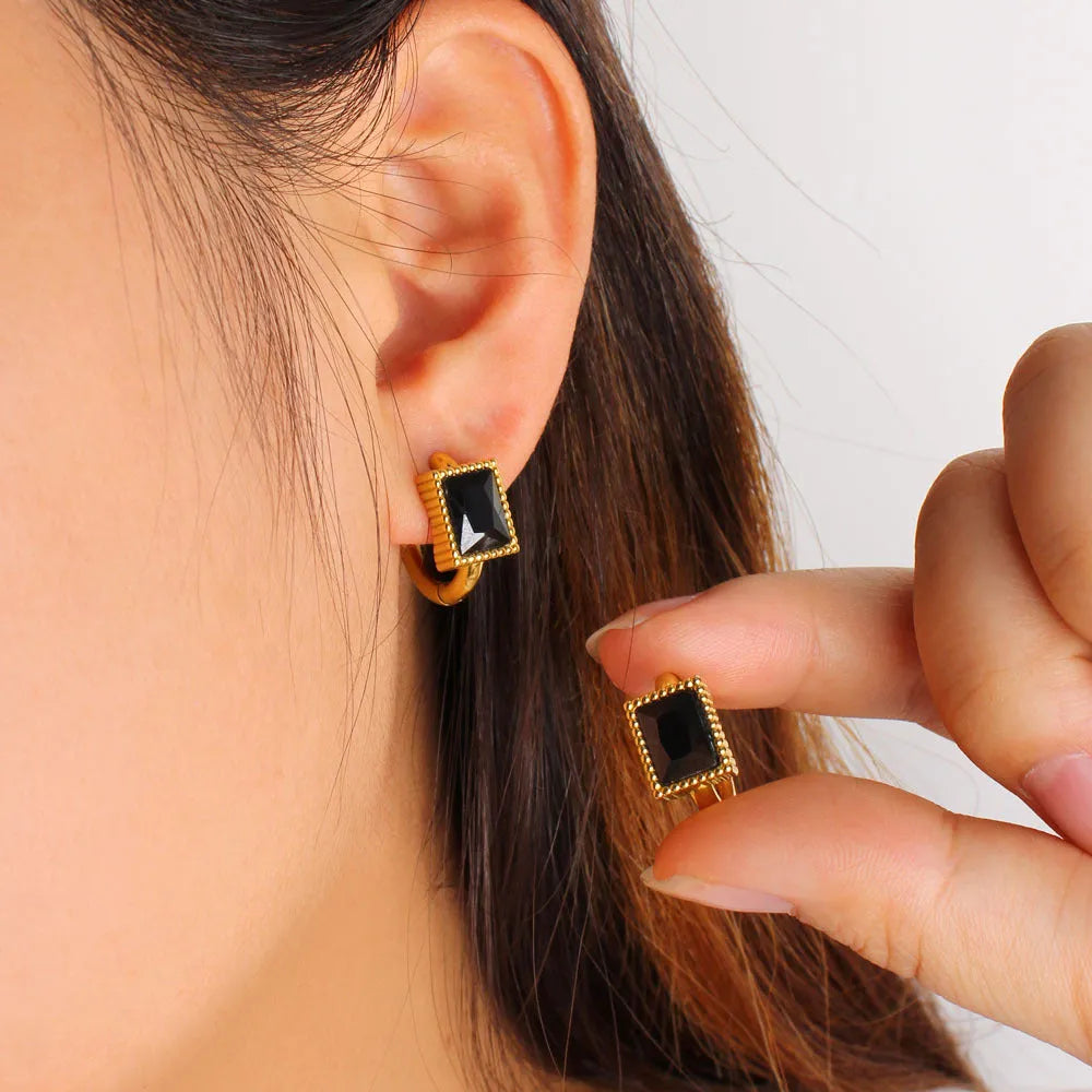 Geometric stainless steel earrings with a square zircon centre and round ring detail in black, green, or white.
