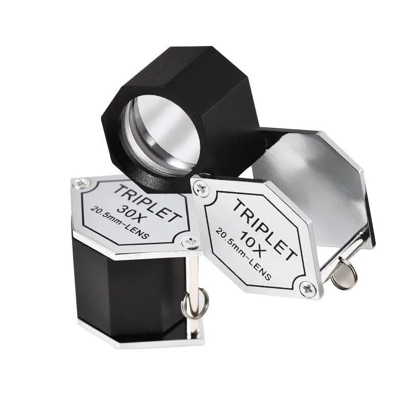 Handheld portable metal magnifying glass with optical glass lens for jewellery and coin identification.