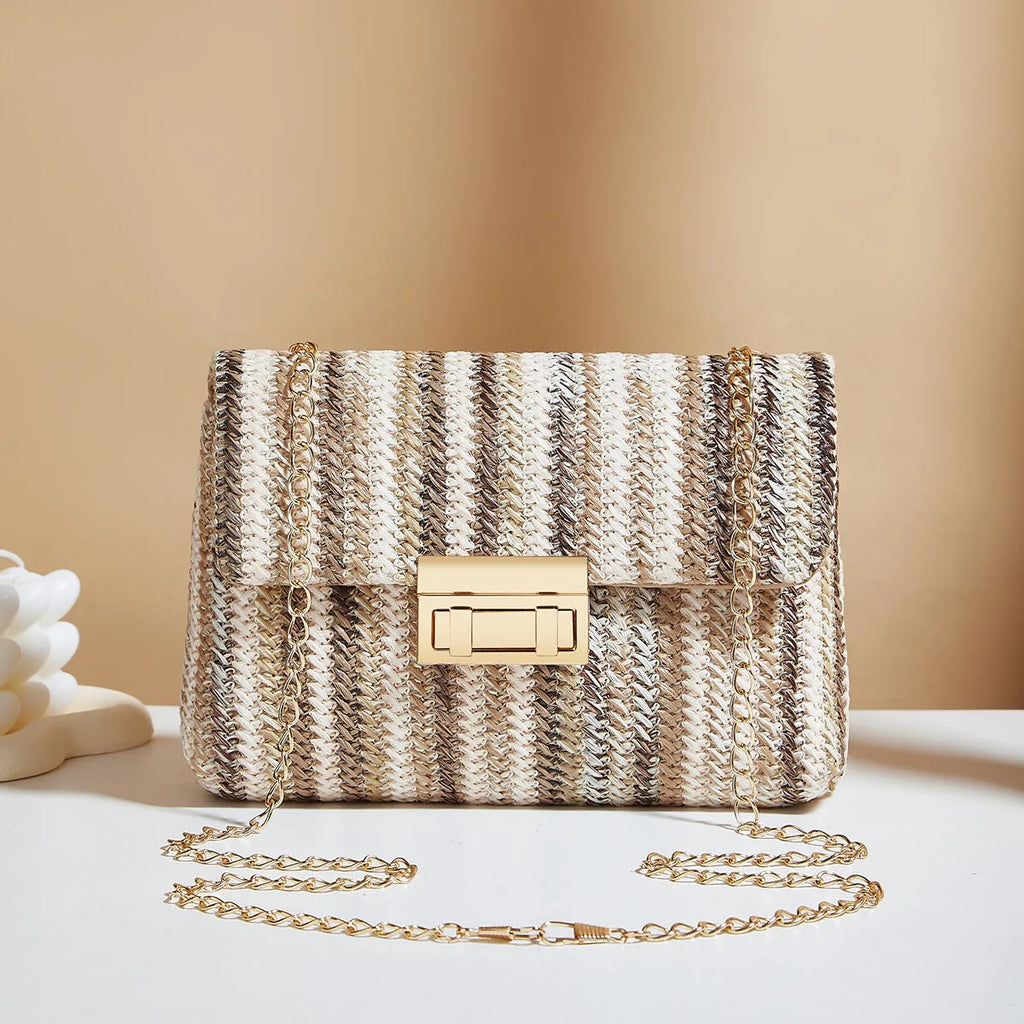 Soft woven straw women's cross-body bag in a small square shape, shown in rainbow colour with a single shoulder strap.
