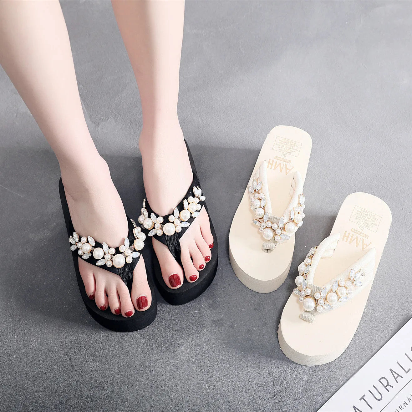 Women's beige high-heeled flip-flops with a cotton cloth upper on a summer background.
