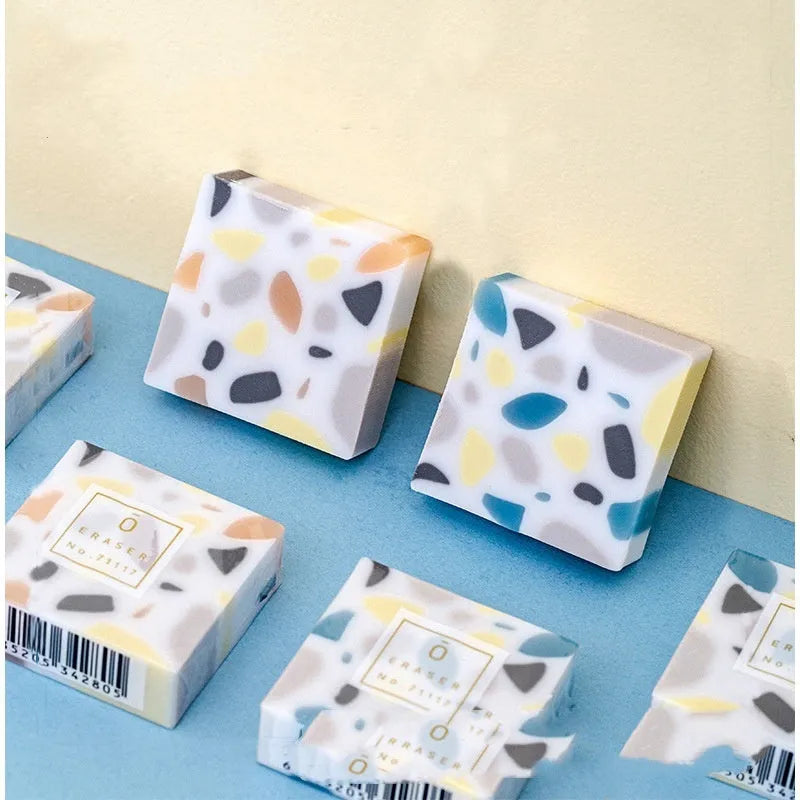 A brick-shaped, single-piece rubber eraser for traceless pencil and charcoal mark removal