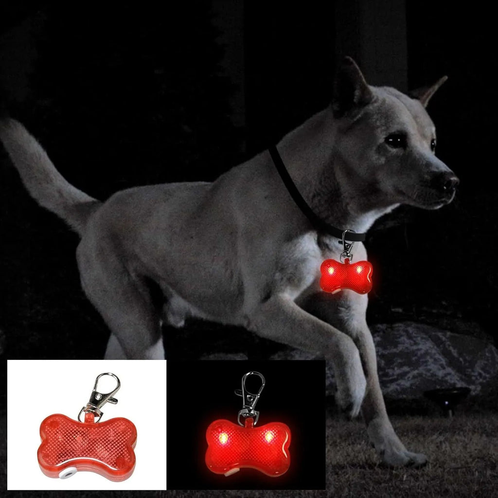 Blue LED bone-shaped luminous pendant attached to a black dog collar, flashing on a dark background.