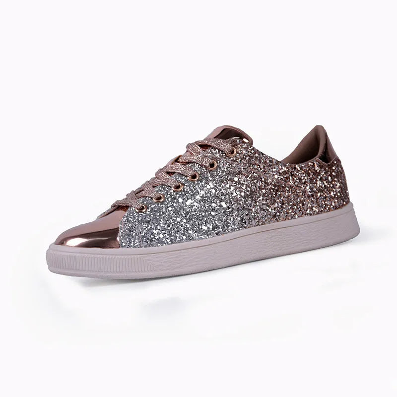 Women's black, gold, and pink sequinned low-top lace-up shoes on a white background.