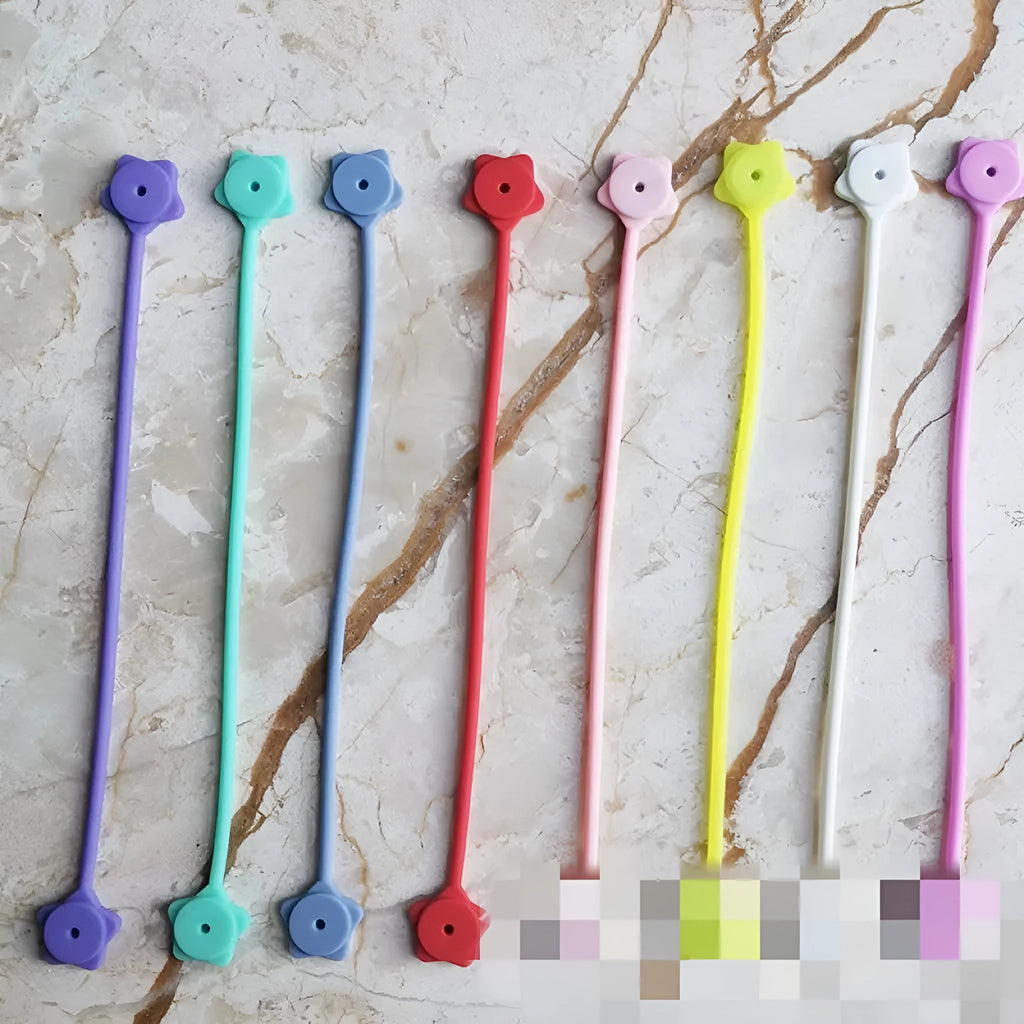 Small silicone and magnet wire winder clip in purple, shown holding a coiled white cable.