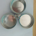 Mini heart-shaped and round stainless steel egg steamer with cooker base on a kitchen counter.