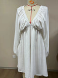 Women's apricot V-neck dress with long puff sleeves and a swing flounced skirt.