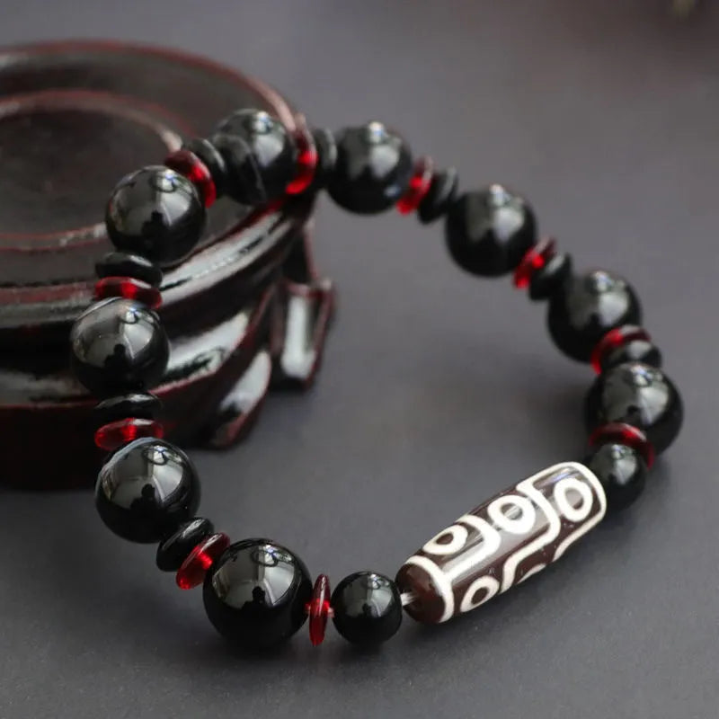 Black agate Dzi bead bracelet with hand-woven construction and 11mm geometric beads
