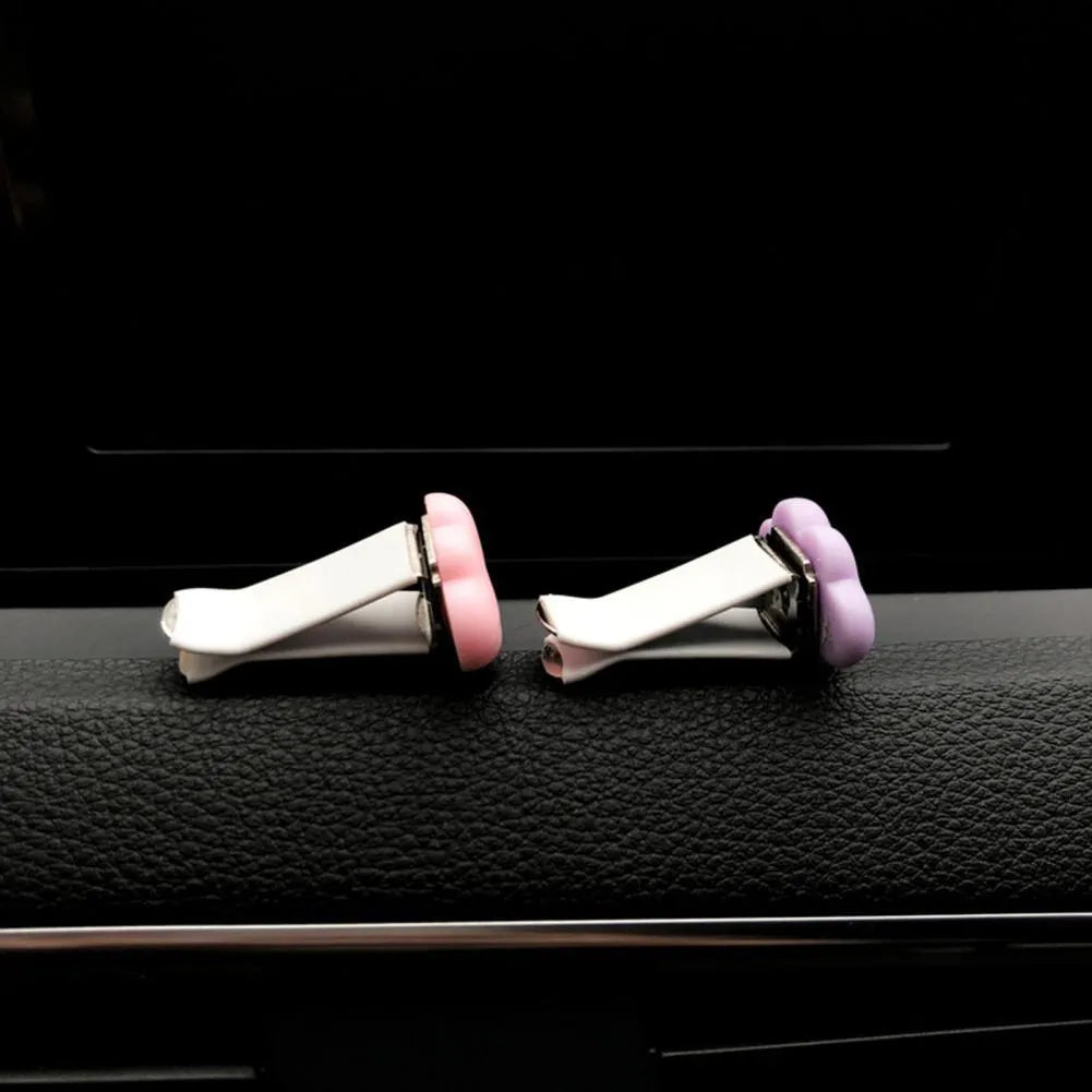 Resin Baiyun cartoon car air freshener clip in pastel colours on a car vent.