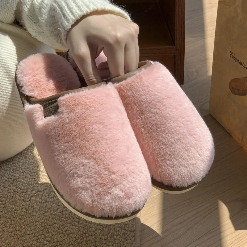 Pair of solid colour plush house slippers with a non-slip PVC sole, shown in coffee brown.