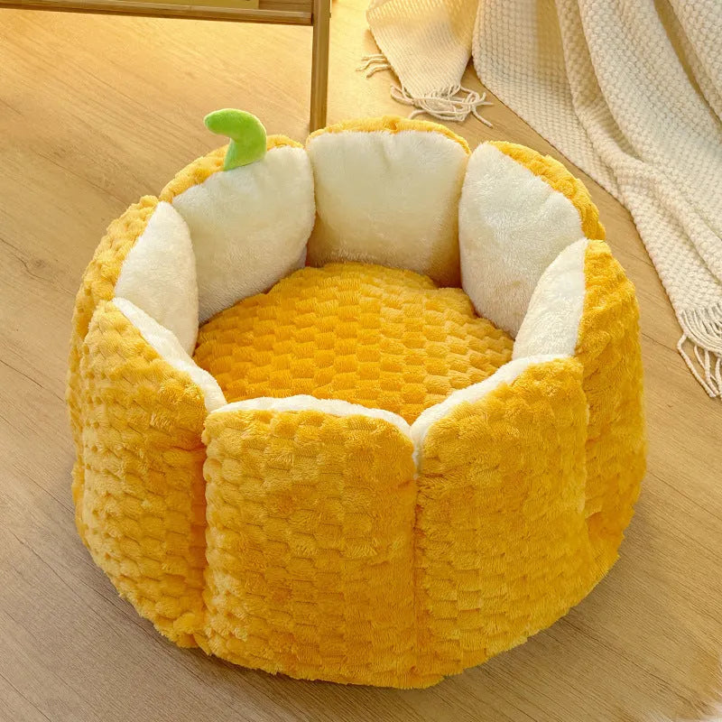 Pumpkin-shaped orange cat nest with raised sides and cotton filling in two size options