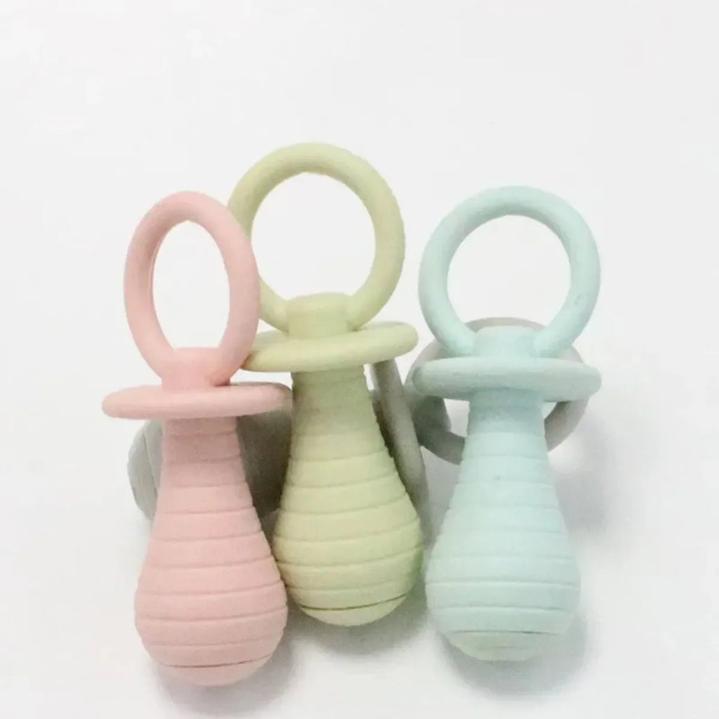 Four coloured TPR rubber pacifier-style pet chew toys with squeakers for puppies and kittens.