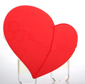 Heart shaped red leather wireless charging mouse pad with indicator light on a desk