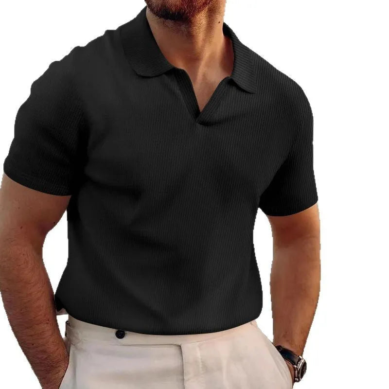 Man wearing a slim fit black heavy waffle knit t-shirt with short sleeves.