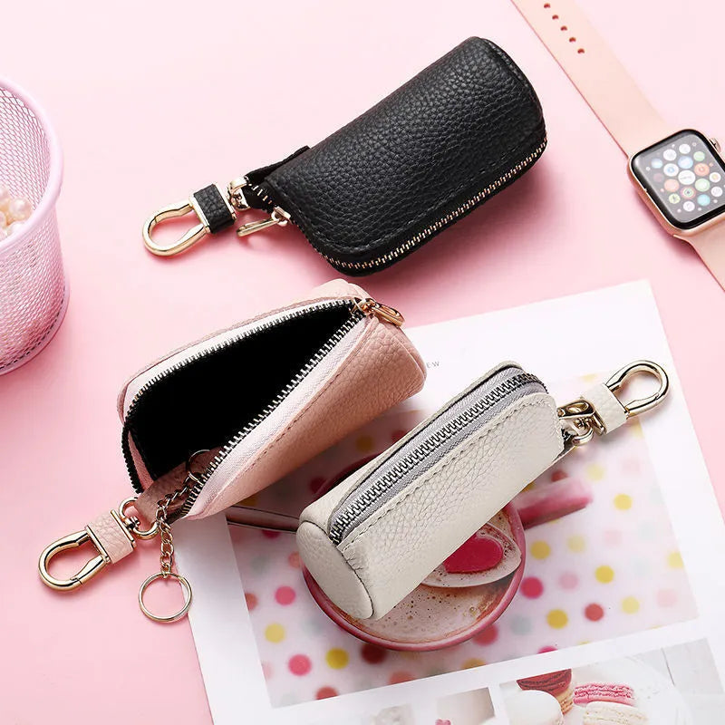 Black pu leather key case with silver zipper closure showing key ring inside