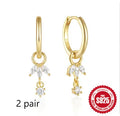 A pair of geometric sunflower design earrings in sterling silver with golden zircon stones.