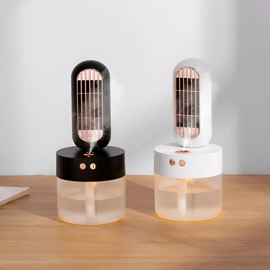 Small black and white personal humidifier fan with oscillating head on a desk