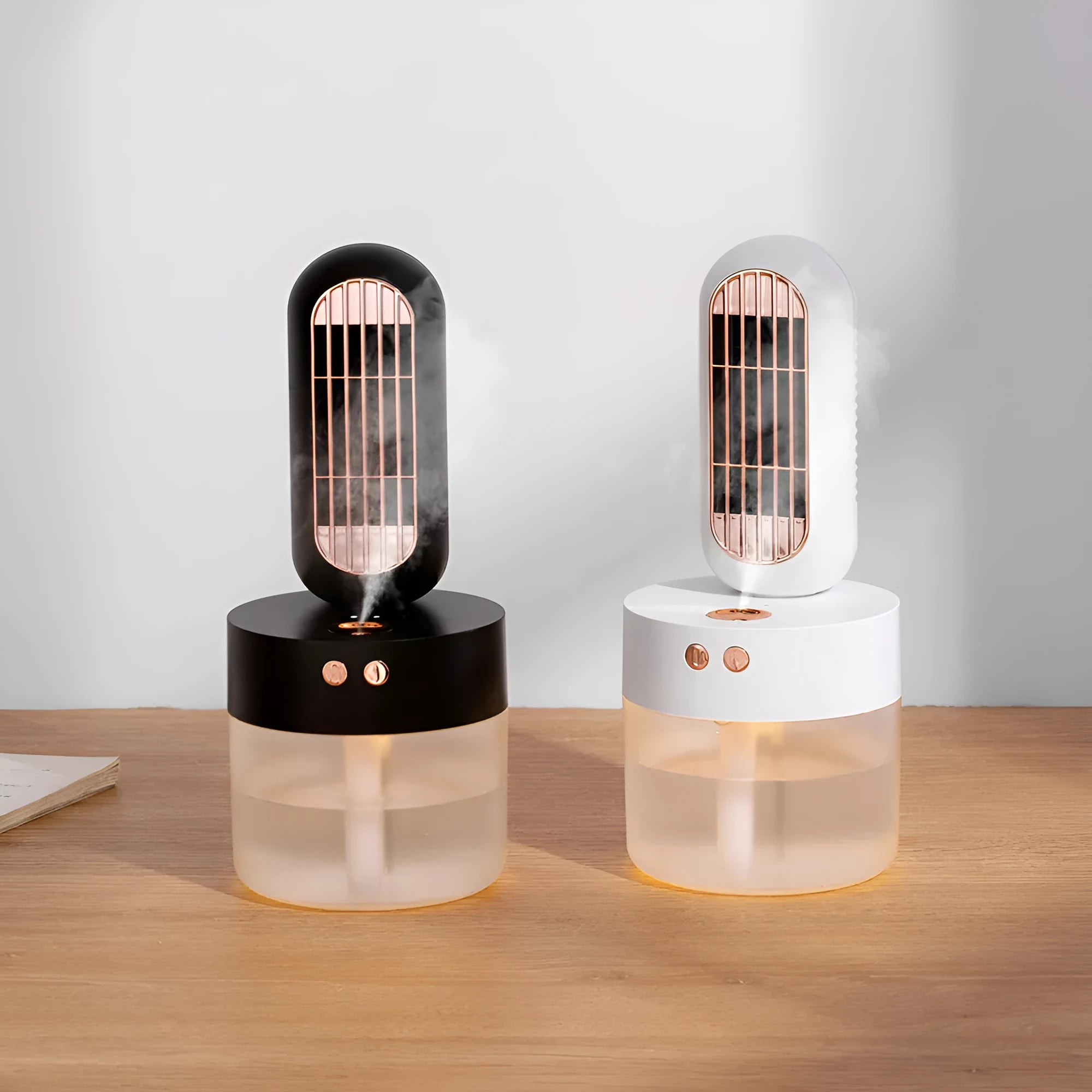 Small black and white personal humidifier fan with oscillating head on a desk