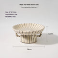 Black and white striped synthetic resin fruit plate on a table